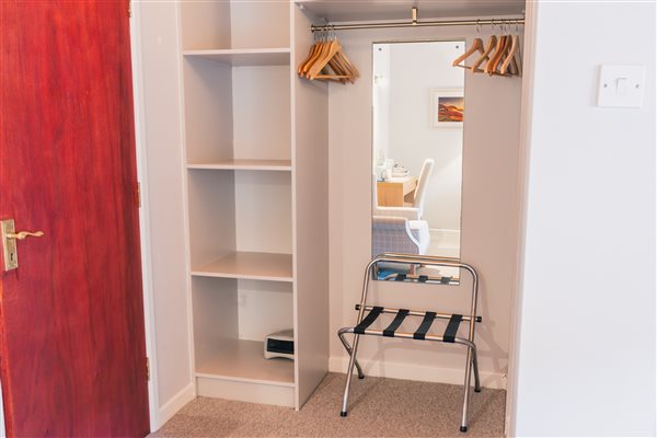 Room 1 open shelves hanging space luggage bag shelf door